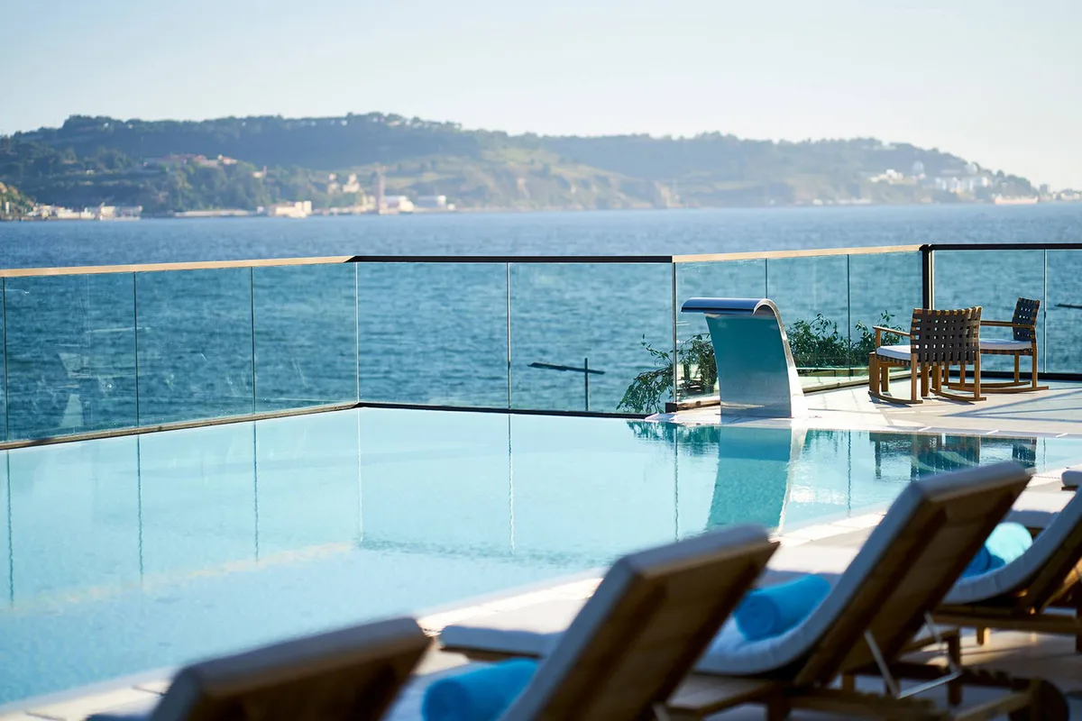 SUD Lisboa infinity pool overlooking the Tagus River and 25 de Abril Bridge