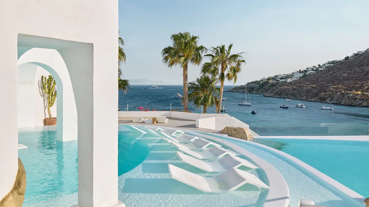 Grecotel Mykonos Blu split-level infinity pool above Psarou Beach