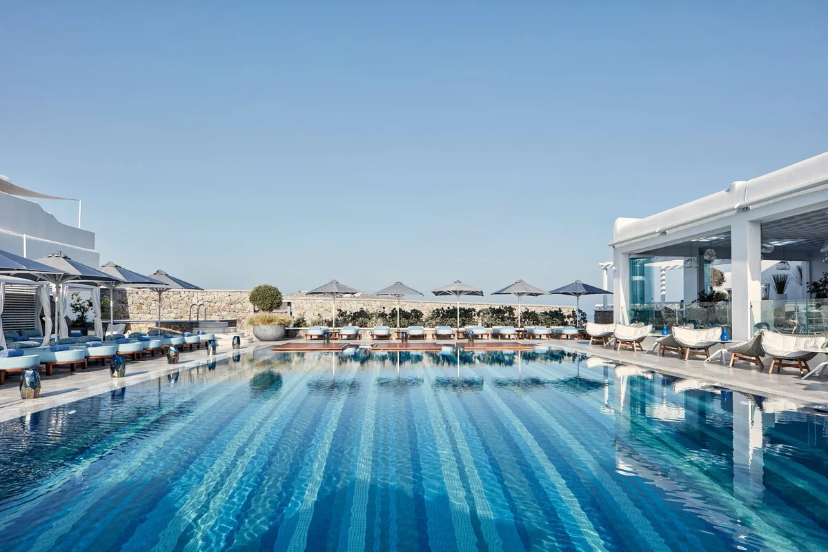 Myconian Kyma design pool deck with views over Mykonos Town and the windmills
